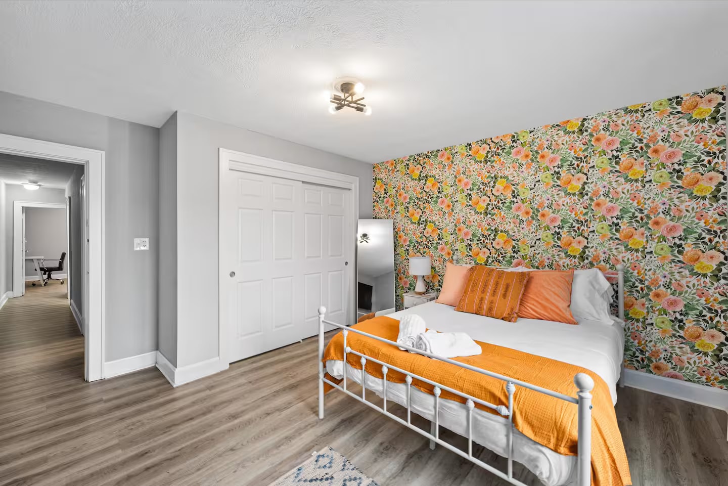 Queen bedroom with floral accent wall