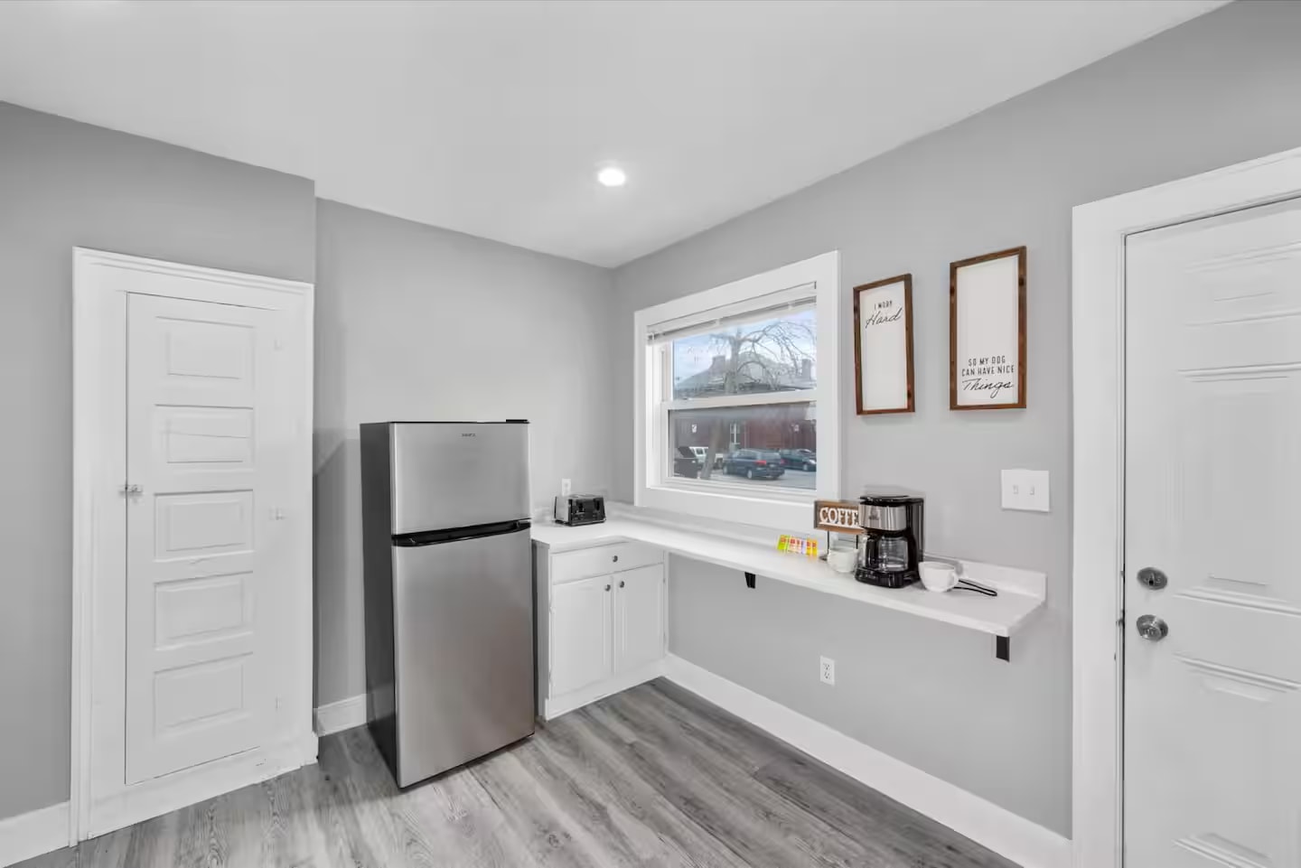 Kitchenette with coffee station and refrigerator