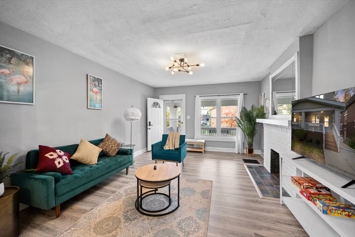 Living room with teal seating and fireplace
